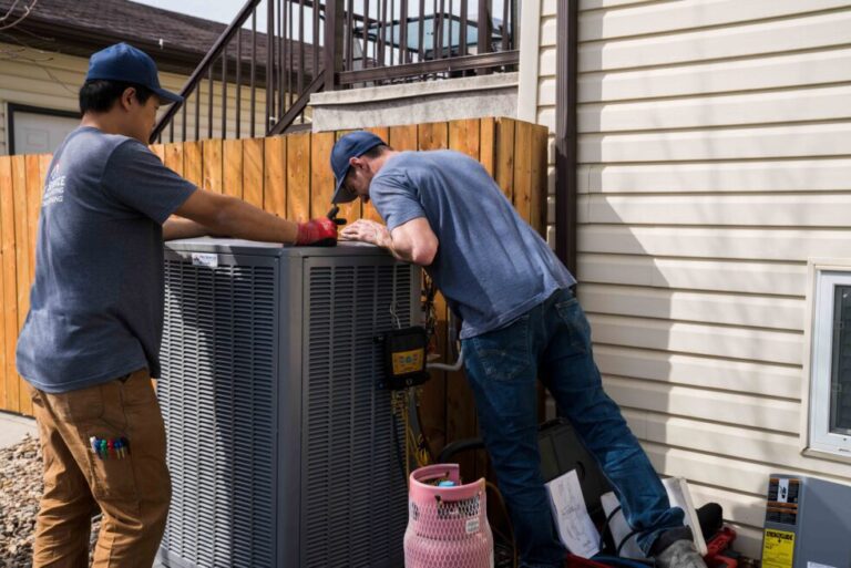 Professional technician performing air conditioning repair in Saskatoon, Canada