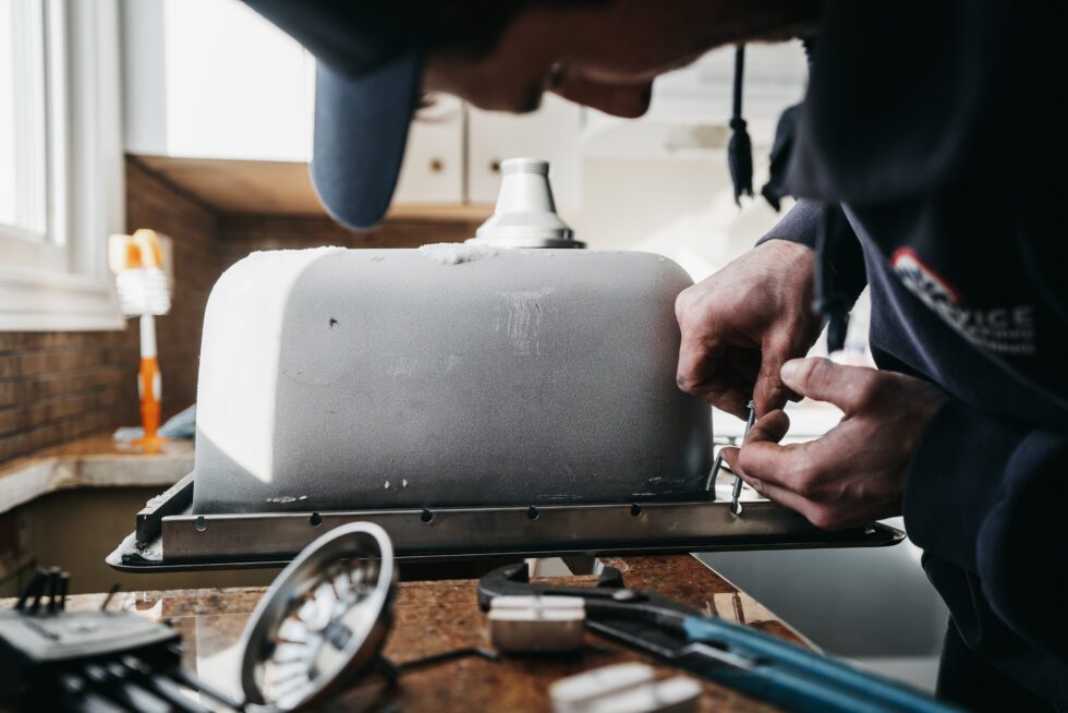 Licensed plumber performing plumbing and heating inspection in Saskatoon, Canada.